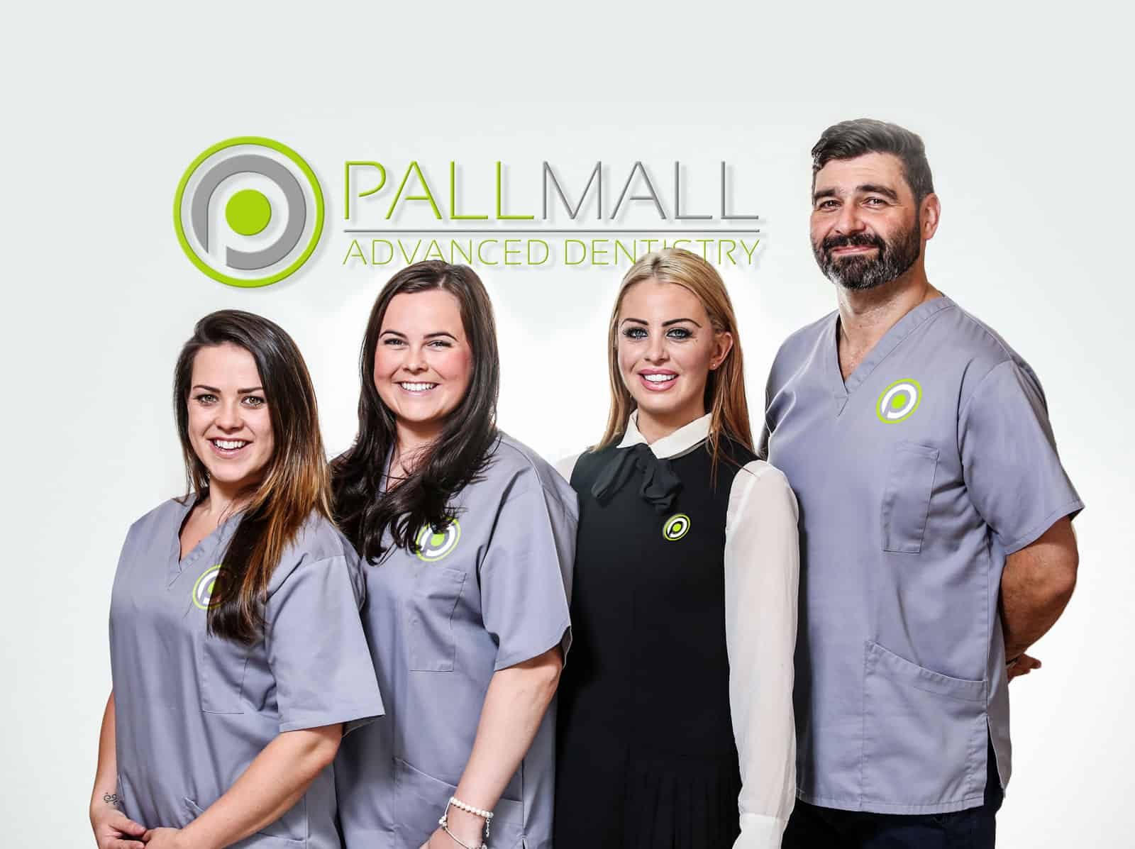 The Pall Mall Dental team in front of the clinic logo